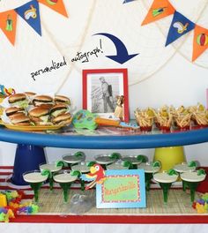 a table topped with plates and sandwiches on top of a blue plate covered in condiments