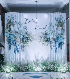 a floral display in front of a white backdrop with blue flowers and the words delite kaval on it