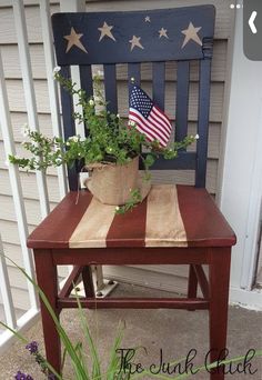 a patriotic chair with an american flag on it and some flowers in the potted planter