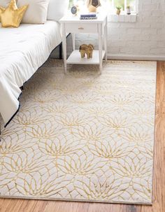 a white and gold rug in a bedroom