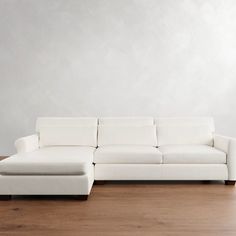 a white couch sitting on top of a wooden floor