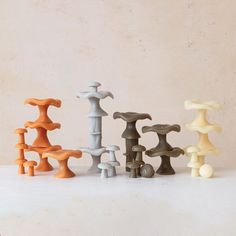 an assortment of different colored vases sitting on a table