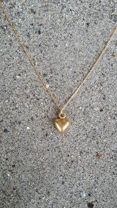 Tiny heart pendant. So cute and dainty can be worn every day with everything!The matte gold plated charm is a dainty 10mm long with a matte gold finish. It  has a delicate 14K gold fill chain with a gold filled clasp in back. Shown here in 17" length.*If you are unsure of the length you need, or would like to wear this item at different lengths, we now offer an adjustable length option! You can add an adjustable end to your necklace using this link: https://www.etsy.com/listing/791277751/necklac Cheap Delicate Chain Jewelry With Heart Pendant, Cheap Minimalist Heart Charm Necklaces, Cheap Minimalist Heart Pendant Necklace, Cheap Gold Heart Necklace Gift, Simple Everyday Charm Necklace With Heart, Simple Everyday Heart Charm Necklace, Everyday 14k Yellow Gold Filled Heart Necklace, Dainty Heart Beads Charm Necklace For Everyday, Dainty Everyday Charm Necklace With Heart Beads