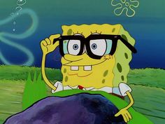 spongebob with glasses sitting on top of a rock