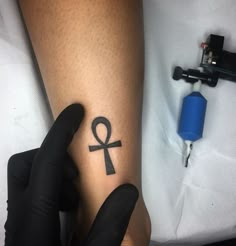 a person with a tattoo on their leg and an egyptian symbol tattooed on the arm