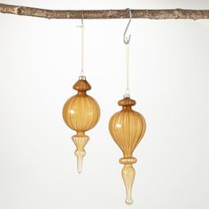 Curvaceous and classy, this duo of lustrous finial ornaments exudes a sophisticated appeal with its exclusive butterscotch hue. The intricate attention to detail found in this collection reflects its true craftsmanship, making these heirloom-style pieces. Over the last 55 years, Sullivans has become an industry leader in home decorations. Our brand is rooted in tradition while incorporating modernized trends to keep your home looking up to date with timeless style. Here at Sullivans, we pride ou Brown Christmas Ornaments, Finial Ornaments, Glass Finial, Brown Christmas, Candle Accessories, Glass Chandelier, Tree Decor, Tree Toppers, Ornament Set