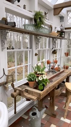 a room filled with lots of windows and plants