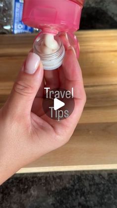 a hand holding a small bottle with travel tips on it and the words travel tips in front of it