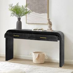 a black console table with two drawers and a potted plant on the top shelf