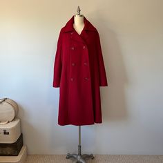 "A gorgeous rich red coat in perfect condition! Its a larger sized coat. A great piece to add to your wardrobe for this fall winter season. There are pockets, it's double breasted with 8 buttons running down the front and there is a satin lining to it with a ribbon to help it keep in place at the waist. The buttons can also close at the neck collar area to keep your chest a bit warmer on colder days and evenings. This coat has a mod style to it so it is not meant to be very fitted to the body. S Elegant Red Long Pea Coat, Elegant Long Red Pea Coat, Red Winter Formal Pea Coat, Red Formal Winter Pea Coat, Elegant Red Pea Coat For Formal Occasions, Elegant Red Pea Coat For Winter, Classic Red Double-breasted Pea Coat, Classic Red Wool Coat, Classic Red Long Wool Coat