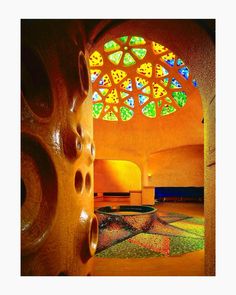 the inside of a building with stained glass windows and colorful tiles on the floor in front of it