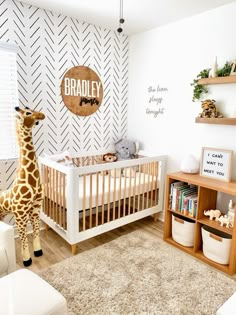 a baby's room with a giraffe stuffed animal in the crib