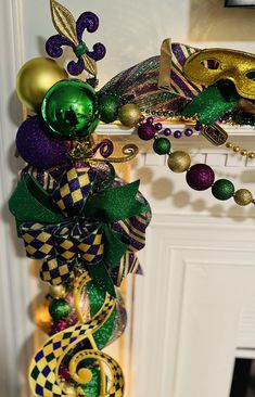 the mardi gras decoration is hanging on the fireplace mantel