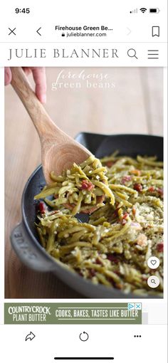 a pan filled with green beans on top of a wooden table