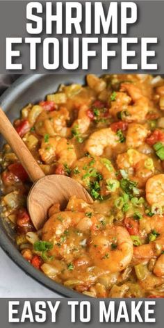 shrimp etouffee in a skillet with a wooden spoon on the side