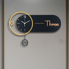 a clock that is on the side of a wall next to a time zone sign