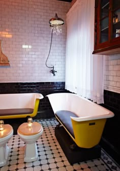 a bathroom with black and white tile flooring and yellow bathtub next to two toilets