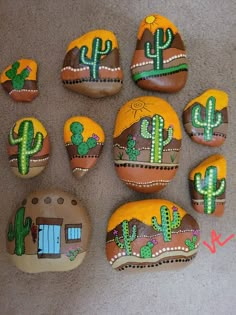 painted rocks with cactus designs on them are arranged in a circle and placed next to each other