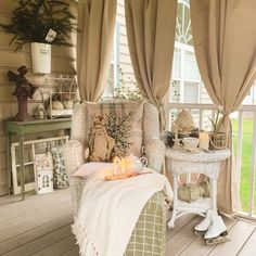 a living room filled with lots of furniture and decor on top of a wooden floor