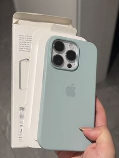 a person holding an iphone 11 in their hand with the case open and it's packaging