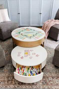 a coffee table that has some cards on it and is in the middle of a living room