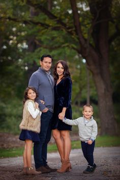 a family posing for a photo in the park