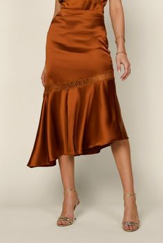 This burnt orange satin skirt is a classy staple, and it is a must-wear for any Fall occasion. It is giving me Serena Van Der Woodsen's thanksgiving outfit vibes. It is super comfortable and easy. Dress it up with its matching lace satin cami or wear it with your favorite sweater for a chic and casual look. Details: 97% Polyester 3% Spandex Side Zipper Closure True to Size Fit Burnt Orange Pencil Skirt Outfit, Elegant Brown Skirt For Date Night, Flowy Satin Skirt For Fall, Brown Party Bottoms With Flowy Fit, Satin Midi Skirt For Date Night, Fitted Satin Bottoms For Fall, Flared Skirt For Date Night In Fall, Flared Skirt For Fall Date Night, Chic Silk Skirt For Fall