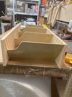 three wooden boxes sitting on top of a workbench in a factory or workshop