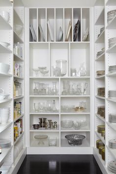 a white pantry filled with lots of dishes