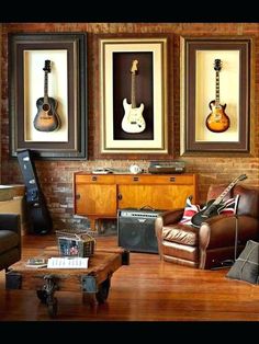 a living room filled with furniture and pictures on the wall next to a guitar case