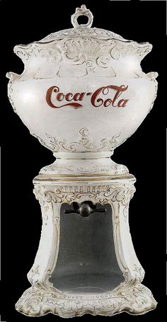 an old fashioned coca cola machine with the lid open