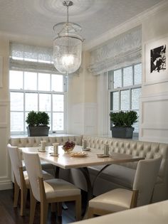 a dinning room table with chairs and a bench