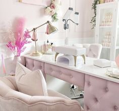 a room with pink furniture and flowers on the wall, including a desk that has a chair in front of it