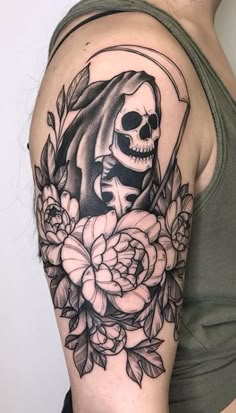 a woman with a skull and roses tattoo on her arm