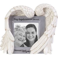 an angel frame with two white wings on the front and back of it, which reads, may angels embrace you and surround you