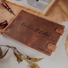 a brown leather guest book with writing on it