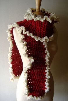 a white mannequin wearing a red and white scarf