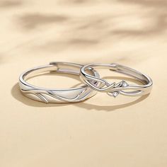 two silver rings sitting on top of each other