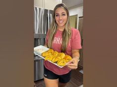 a woman holding a plate of food in her hands