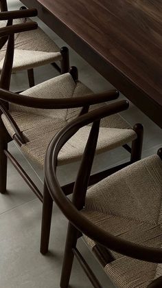 a row of chairs sitting on top of a wooden table