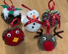 four christmas ornaments are sitting on a table