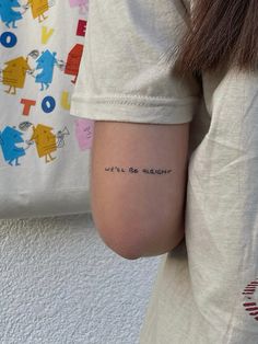 a woman's arm with the words we'll be alright tattooed on it