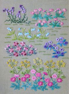 some flowers are on the side of a piece of fabric, and one is in different colors