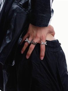 a person with their hand on the back of someone's pants, wearing two rings