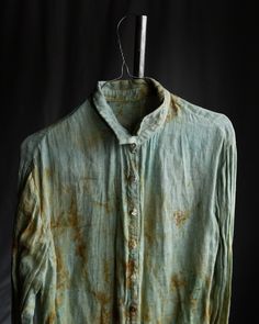 Hand dyed linen gauze shirt FADE This shirt is made of natural linen gauze, gentle semi sheer fabric with visible texture. The color is very pale teal with splotches in rusty orange and pale blueish shades. Each shirt is hand dyed with iron and copper rust to achieve imperfect random splotchy pattern. Shirt has raw edged button closure, straight hem, small collar which is possible to turn up and down, little cuffs. Button line was hand stitched with natural linen thread. Buttons are mixed of vintage mother of pearl ones, coconut and other random ones, each is different. Total length ~65cm. All the materials are prewashed to avoid shrinkage. Distressed Button Up Shirt, Vintage Faded And Bleached Tops, Vintage Faded Bleached Tops, Casual Distressed Button-up Shirt, Paint On Shirt, Stained Clothes, Distressed Cotton Button-up Shirt, Ruined Clothes, Thread Buttons