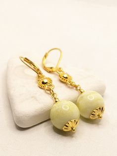 Beautiful earrings made with gold plated findings and jade beads.  approximately 5 cm long. Yellow Earrings With Ear Wire For Wedding, Yellow Ear Wire Earrings For Wedding, Gold Jade Beaded Jewelry, Elegant Earrings With Gold Beads, Elegant Beaded Drop Earrings With Lever Back, Elegant Gold Beaded Earrings For Gift, Yellow Wedding Earrings With Ear Wire, Elegant Yellow Jewelry With Dangling Beads, Gold Jade Earrings