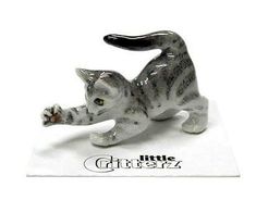 a small figurine of a cat laying down