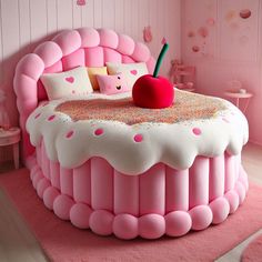 a bed made to look like a pink cake with sprinkles and a cherry on top