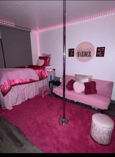 a bedroom with pink carpet and lights on the walls, bed in corner, fuchsia rug