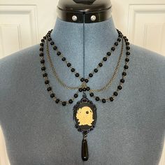 Handcrafted Goth Victorian Necklace With Black Onyx Pendant - 18" L With 4" Drop (1) Highly Detailed Skull And Roses Resin Cameo (1) Black Metal Enamel Bezel Frame (1) 10x30mm Black Onyx Pendant Drop (36") 6mm Black Pearl Glass And Bronze Rosary Chain (12") Antique Bronze Iron Cross Chains (1) Antique Bronze Floral Toggle Clasp Skull Rosary, Goth Victorian, Skull And Roses, Black Onyx Pendant, Victorian Necklace, Iron Cross, Fun Clothes, Onyx Pendant, Gothic Necklace